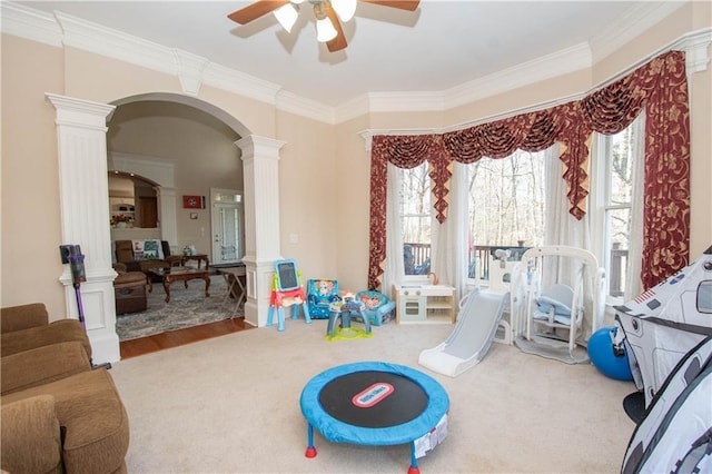 recreation room with crown molding, decorative columns, and ceiling fan