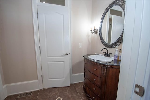 bathroom featuring visible vents, baseboards, vanity, and tile patterned flooring