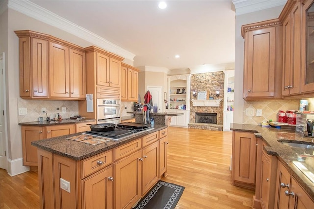 kitchen with oven, open floor plan, and ornamental molding