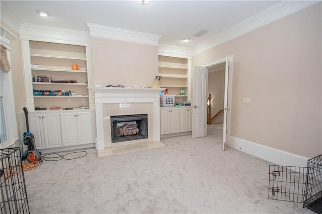 living area featuring built in shelves, light carpet, ornamental molding, and a high end fireplace