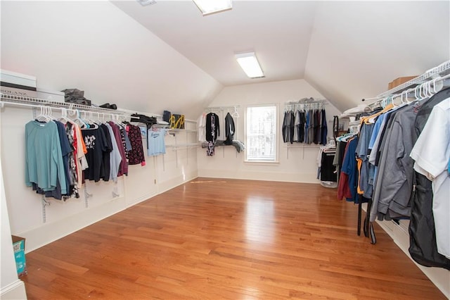 spacious closet with lofted ceiling and wood finished floors