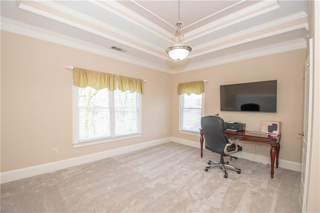 carpeted home office featuring a tray ceiling, visible vents, baseboards, and ornamental molding