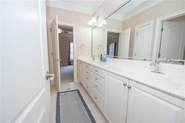 full bath featuring tile patterned flooring, crown molding, double vanity, and a sink