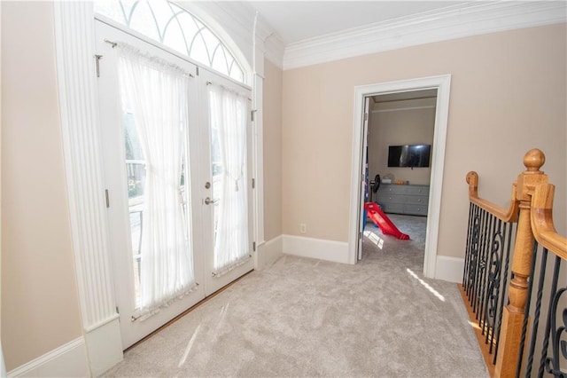 empty room with baseboards, carpet floors, and crown molding