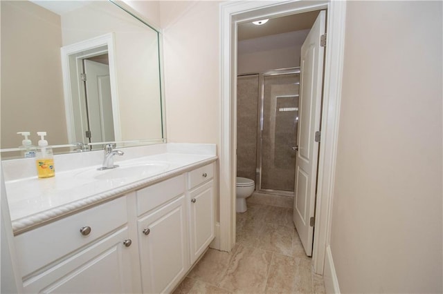 full bath with vanity, toilet, and a stall shower