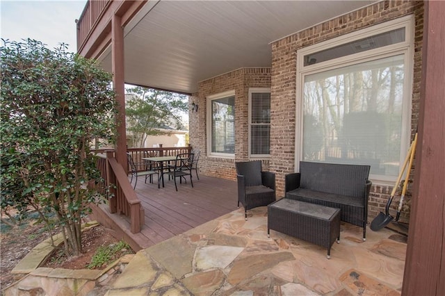 wooden terrace with outdoor dining space