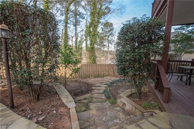 view of yard with a deck and fence