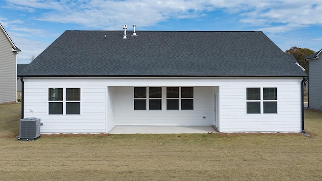 back of property featuring a patio area, roof with shingles, a yard, and central air condition unit