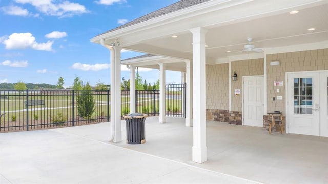 view of patio with a ceiling fan and fence