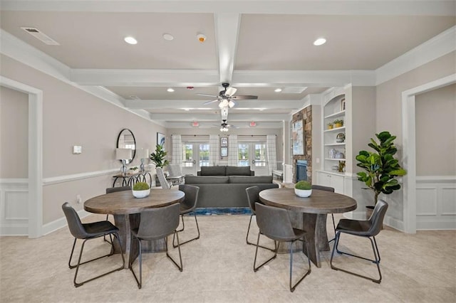 dining room featuring built in shelves, french doors, visible vents, a decorative wall, and beamed ceiling