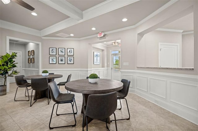 dining area with a wainscoted wall, crown molding, a decorative wall, beam ceiling, and recessed lighting