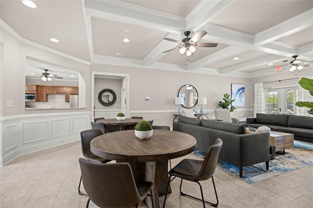 dining area featuring coffered ceiling, a wainscoted wall, beamed ceiling, a decorative wall, and recessed lighting