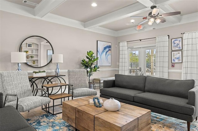 living area featuring beam ceiling, visible vents, wainscoting, and french doors