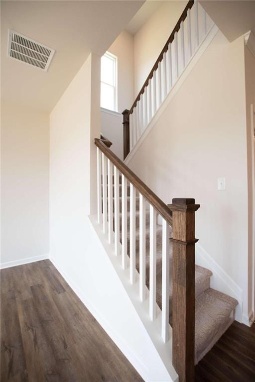 staircase with wood-type flooring