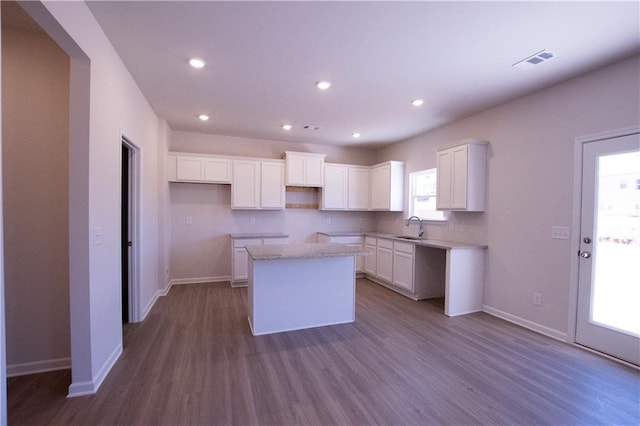 530 River Run Dr, Dallas, GA 30132 - kitchen with a sink, a kitchen island, baseboards, dark wood-type flooring, and recessed lighting