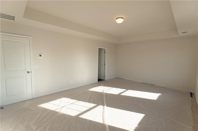 530 River Run Dr, Dallas, GA 30132 - spare room featuring light carpet, a tray ceiling, and baseboards