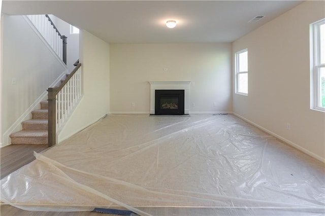 530 River Run Dr, Dallas, GA 30132 - unfurnished living room with stairs, a fireplace, and baseboards