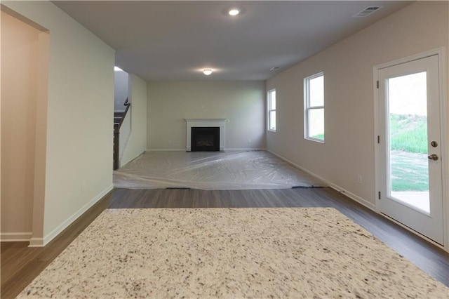 530 River Run Dr, Dallas, GA 30132 - unfurnished living room featuring dark wood-style flooring, stairs, a fireplace, baseboards, and recessed lighting
