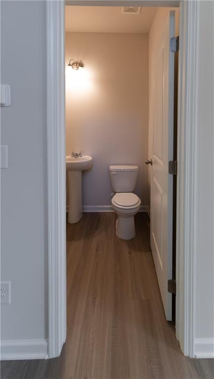 530 River Run Dr, Dallas, GA 30132 - half bath with wood finished floors, toilet, baseboards, and a sink