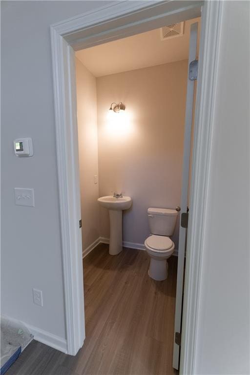 530 River Run Dr, Dallas, GA 30132 - half bathroom featuring wood finished floors, baseboards, toilet, and a sink