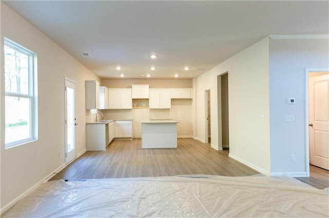 530 River Run Dr, Dallas, GA 30132 - kitchen featuring a sink, white cabinetry, light wood-type flooring, a kitchen island, and recessed lighting