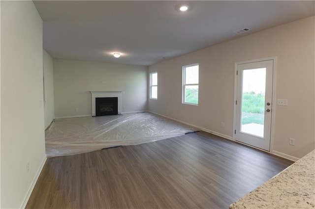 530 River Run Dr, Dallas, GA 30132 - unfurnished living room with wood finished floors, baseboards, a fireplace with flush hearth, and recessed lighting