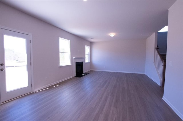 530 River Run Dr, Dallas, GA 30132 - unfurnished living room with a fireplace, dark wood-style floors, and baseboards