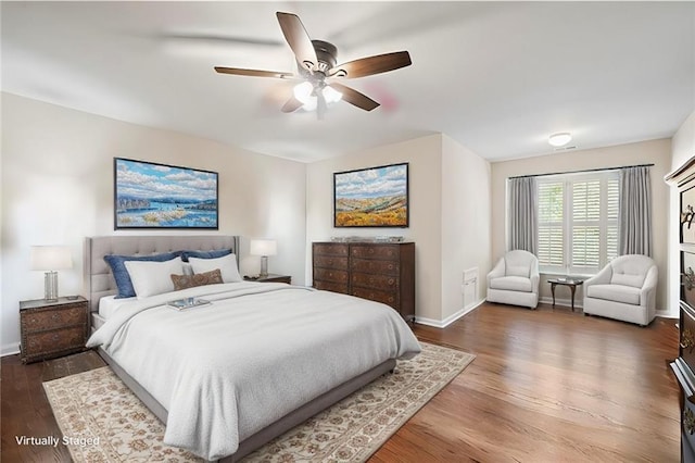 bedroom featuring ceiling fan, baseboards, and wood finished floors