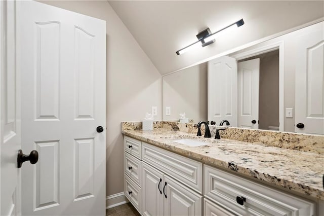 bathroom with vanity and vaulted ceiling