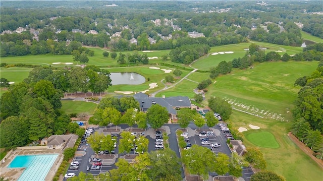 drone / aerial view with a water view and view of golf course