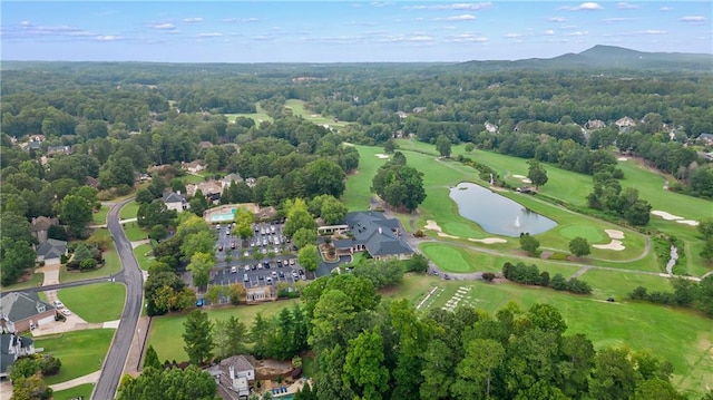 drone / aerial view with a water view and view of golf course