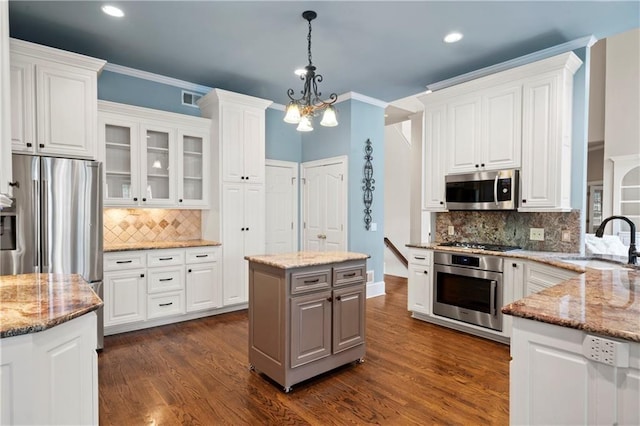 kitchen featuring a sink, appliances with stainless steel finishes, and white cabinetry