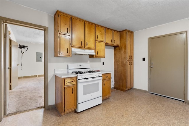 kitchen with a textured ceiling, electric panel, and white gas stove