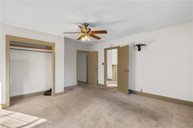 unfurnished bedroom featuring ceiling fan, light colored carpet, and a closet