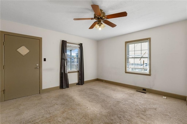 empty room with light carpet and ceiling fan