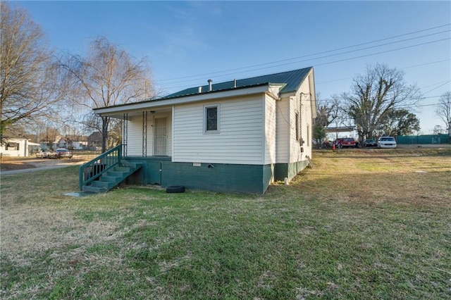 view of side of property with a lawn