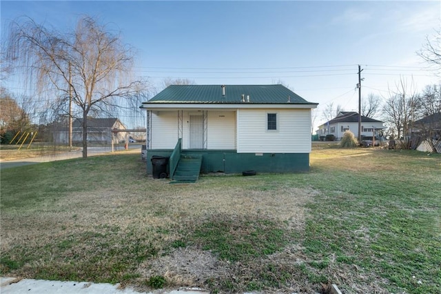 back of property featuring a lawn