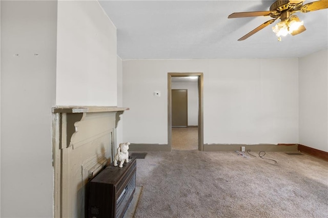 unfurnished living room with ceiling fan and carpet flooring