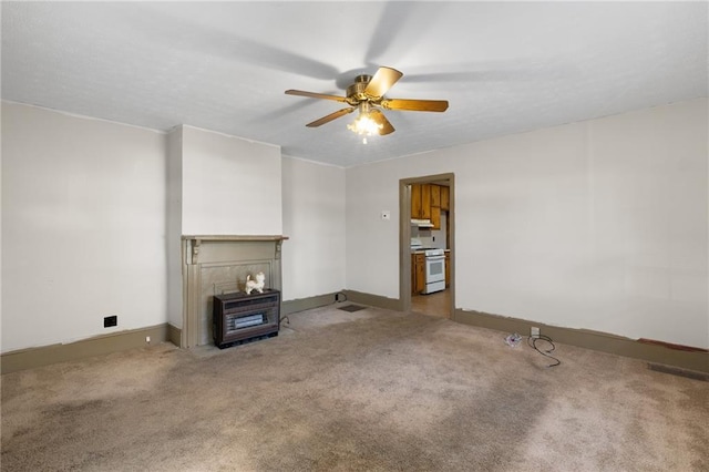 unfurnished living room featuring a fireplace, ceiling fan, and carpet