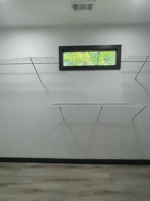 spacious closet featuring visible vents