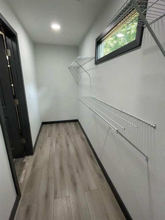 walk in closet with light wood-type flooring