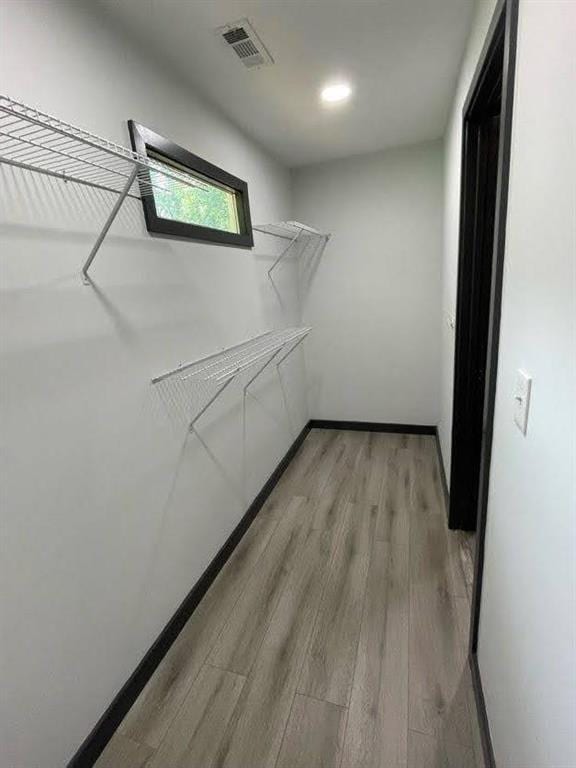 walk in closet with visible vents and light wood-type flooring