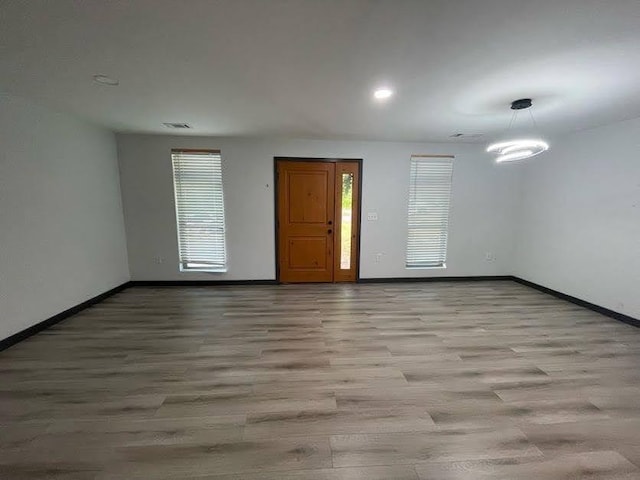 interior space with visible vents, wood finished floors, baseboards, and recessed lighting
