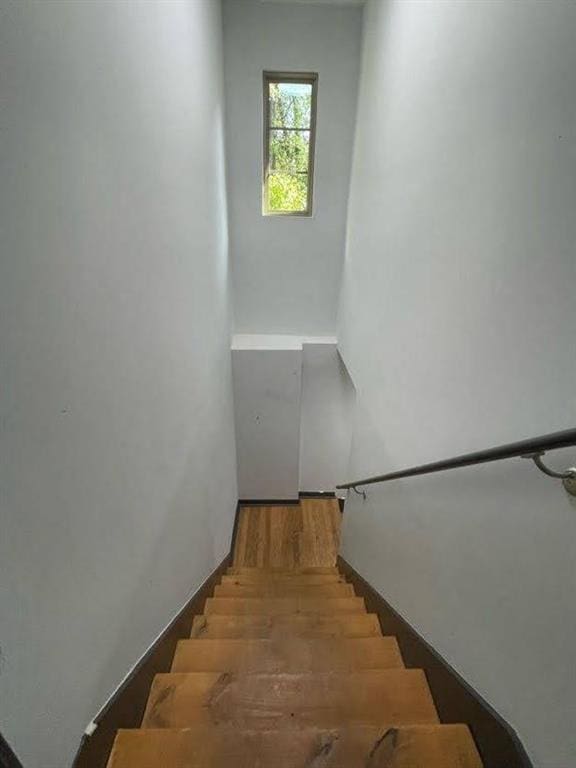 stairway with wood finished floors