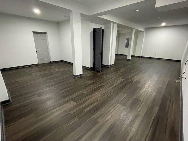 finished basement featuring baseboards, dark wood-type flooring, and recessed lighting
