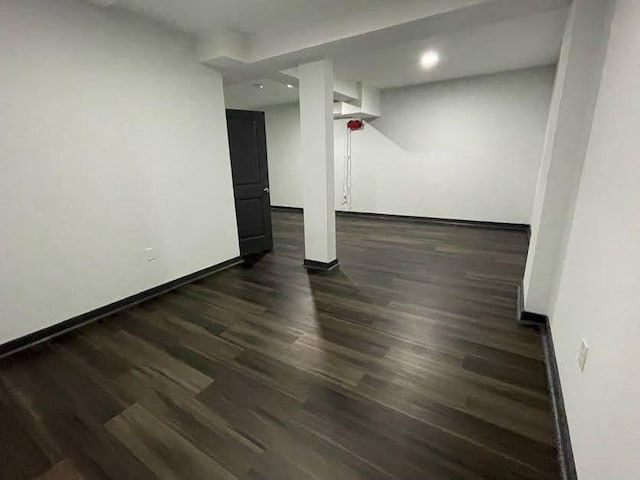 finished basement with baseboards and dark wood-style floors