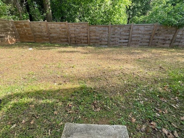 view of yard with a fenced backyard