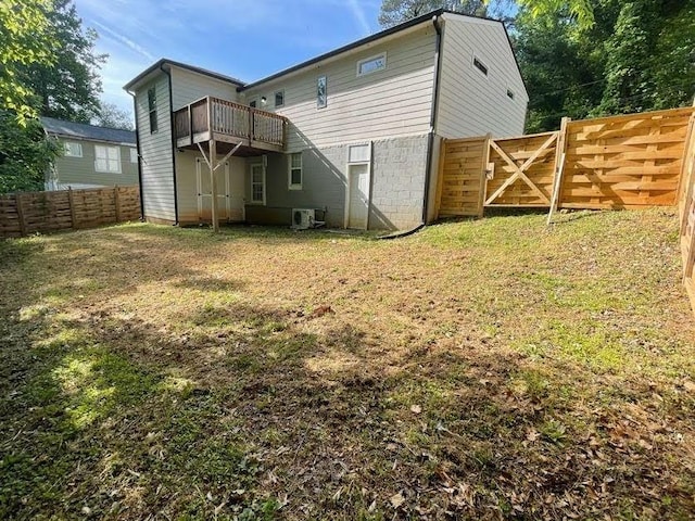 back of property featuring fence, a lawn, central AC, and a deck
