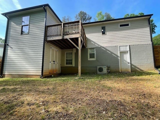 back of house with ac unit and a deck