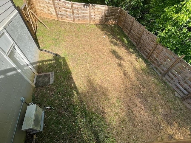 view of yard with a fenced backyard and ac unit